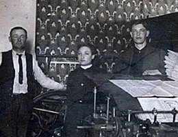 Perkins used this printing press to run his mail order and newspaper businesses; (left to right): Fred Wixson, Ada Converse, Edwin E. Perkins (also in the inset)